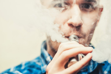Close up of a man vaping.