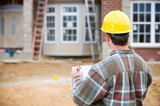 Construction: Home Inspector Doing Review
