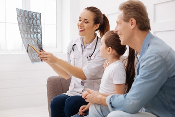 Joyful neurosurgeon informing her patient about progress