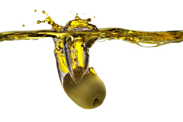 Olive falling into olive oil
