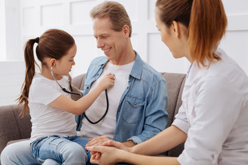 Obraz premium Future little doctor consulting her dad