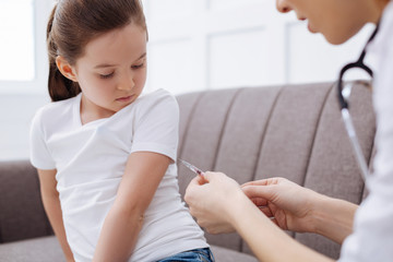 Brave young girl receiving an injection