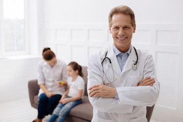 Obraz premium Distinguished handsome doctor posing in his office