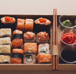 Set of sushi maki and rolls closeup in carton delivery box
