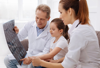 Curious little patient asking her doctors some questions