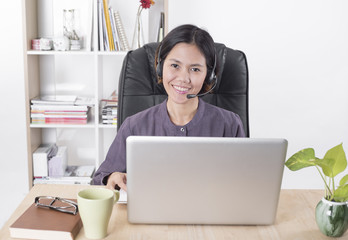 Asia women happy smiling customer support operator with headset in office.