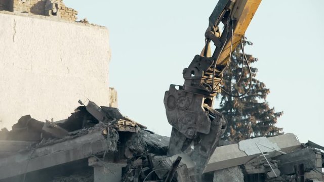 Building demolition procedure, high reach excavator eliminating old construction