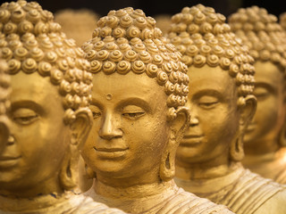 Close-up on head buddha statue, soft focus.