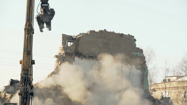 Demolition tool pulling down high wall, removing obstacle, breaking regime