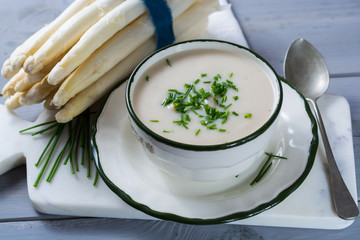 Spring season - white  asparagus soup with fresh green chives ready to eat