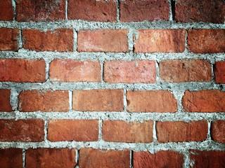 Old grunge brick wall background with vignetted corners,