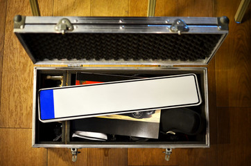 Empty license plate in suitcase on the floor, mockup