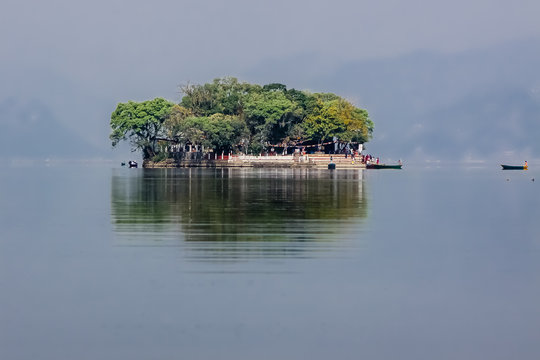 Tal Barahi Temple island in hazy Lake Phewa with reflections, Pokhara, Nepal