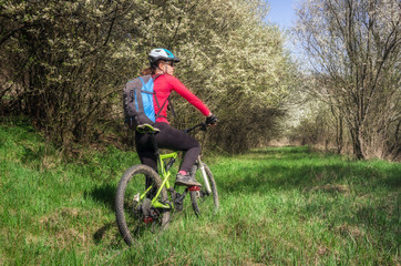 Woman resting after cycling in the forest