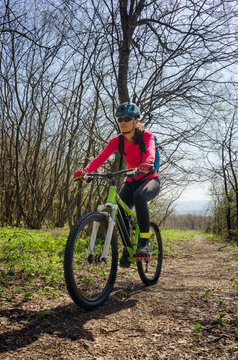 Woman cycling in the forest