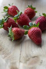 Big fresh strawberries are on the wooden background
