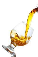 Cognac glass with cognac on white background