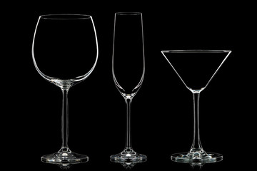 Silhouette of different glasses on black background