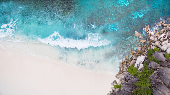 Seychelles Island white tropical paradise beach, turquoise sea and granite rocks aerial landscape. La Digue Grand Anse beach seascape. 