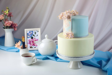 Spring morning still life cake in pastel colours with flowers