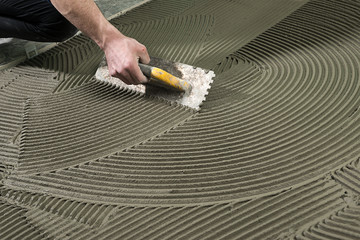 Worker Applying Ceramic Glue    