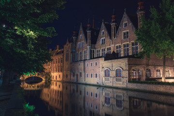 Night view of typical canal of medieval city of Brugge with traditional houses