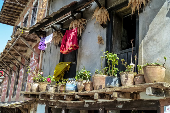 Typical Nepalese building with balcony decorated with flowerpots and cloth ropes, Bandipur, Nepal