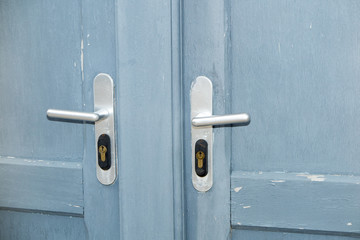 blue door with its two recent cuffs usable to make a background or a wallpaper