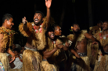 Fijian men dancing a traditional male dance meke wesi in Fiji