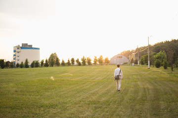 Man walking away on green lawn