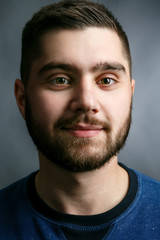 Portrait of handsome smiling man with dark beard