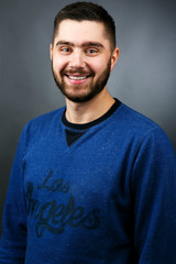 Handsome cheerful man in blue sweater