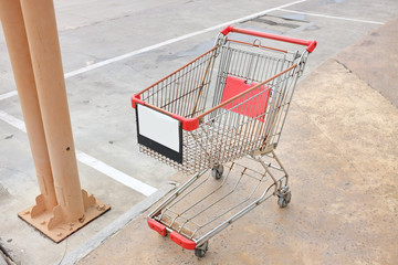 an empty shopping cart at carpark