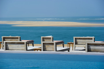 Fototapeta na wymiar Beautiful tropical beach with chairs and swimingroom