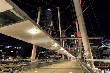 Naklejka premium Kurilpa Bridge southside architecture, illuminated pedestrian walkway, looking towards Brisbane CBD