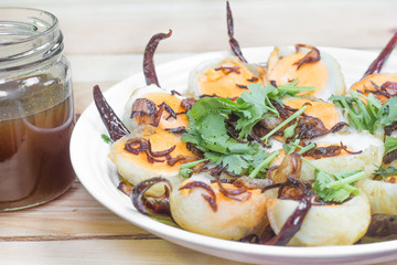 Thai food egg manu Akelokeki with fried pepper and fried onions.