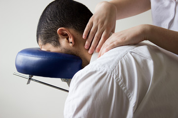 business man receiving shiatsu on massage chair