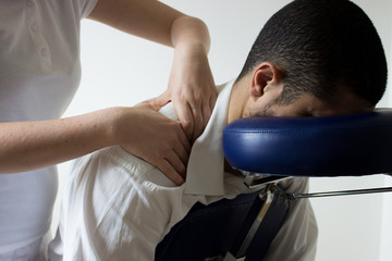 business man receiving shiatsu on massage chair
