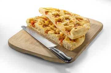 Apulian flat bread with tomatoes and knife
