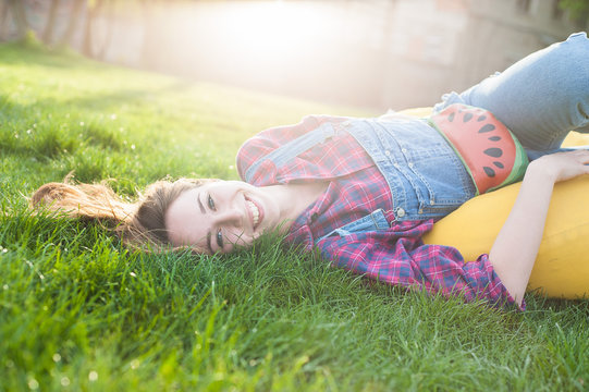 Smiling girl is rest on the grace.
