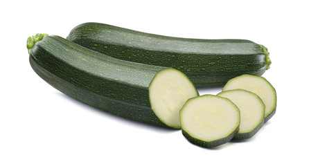 Whole zucchini and round pieces isolated on white