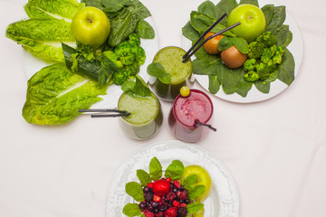 Healthy green and red smoothies and ingredients - superfoods, detox, diet, health, vegetarian food concept.