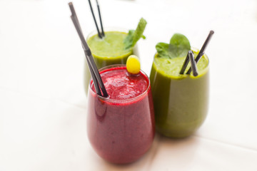 Healthy green and red smoothies - superfoods, detox, diet, health, vegetarian food concept.
