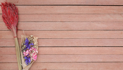 Dried bush flowers on a wooden plank background with copy space.