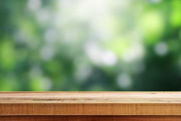 Wooden desk and blur green background.