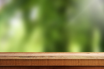 Wooden table and blur garden background.