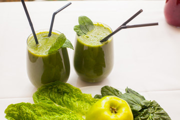 Healthy green smoothie and ingredients - superfoods, detox, diet, health, vegetarian food concept.