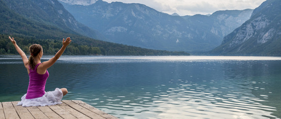 Woman meditating at the lake