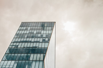 Modern office building with stormy cloudy sky