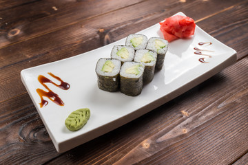Japanese cuisine. Sushi roll with avocado on white background